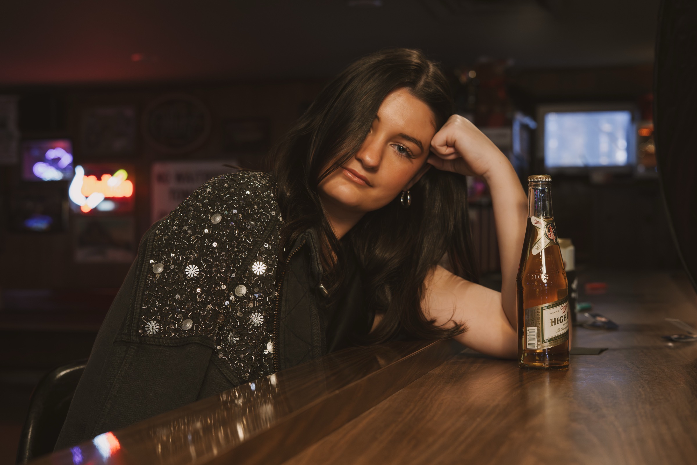 A regular leaning on the bar with a High Life at The Brickette Lounge