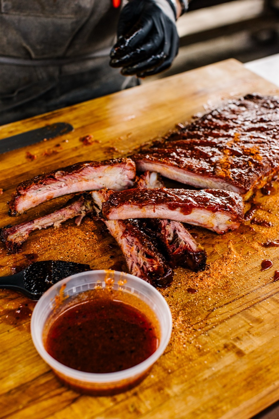 Pit-smoked ribs glazed on the wood board