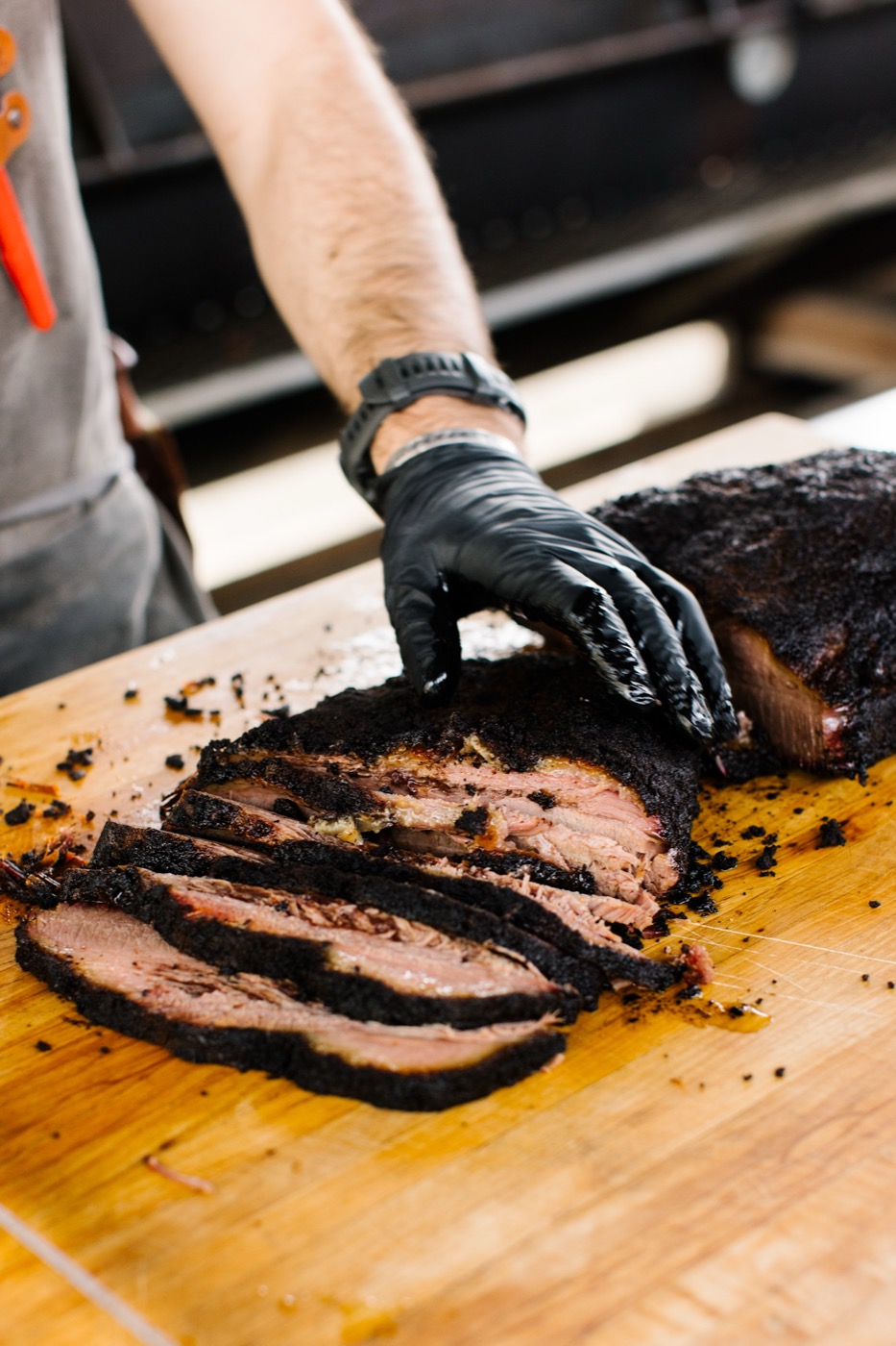 Sliced brisket fanned across the cutting board